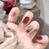 مجموعة من 24 ظفرًا صناعيًا أحمر قصير بتصميم زهرة ورقائق ذهبية